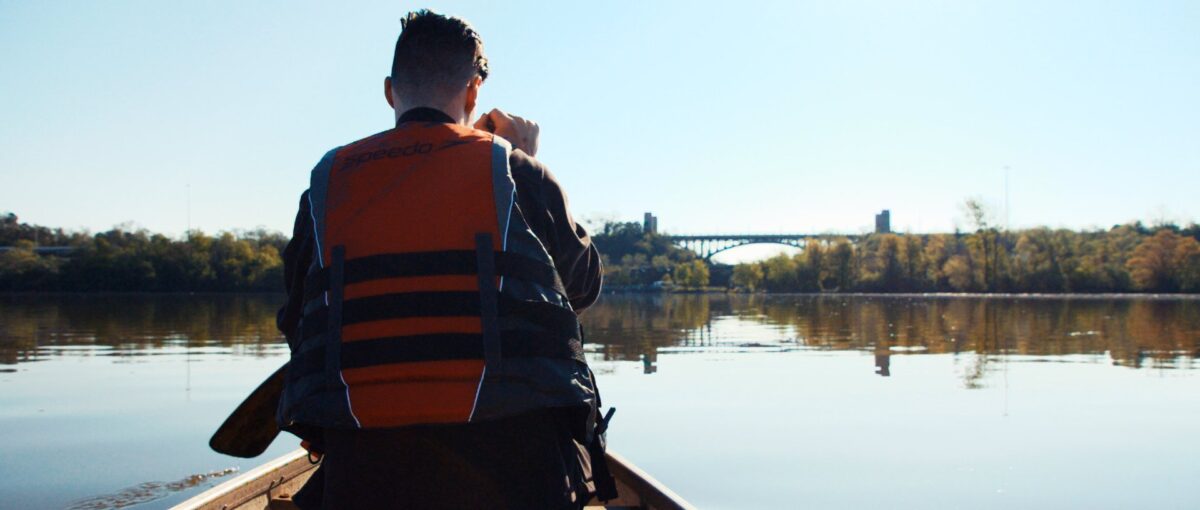 Photo of an individual kayaking on the lake.